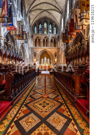 Gothic St. Patrick Cathedral in Dublin with floor tiles, arches, stained glass, choir stalls Gothic St. Patrick Cathedral in Dublin with floor tiles, arches, stained glass, choir stalls 119618215