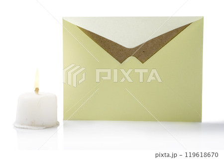 Envelope and postcard with candle on white background Envelope and postcard with candle on white background 119618670