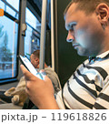 A man with a cat and smartphone in public transport. High quality photo 119618826