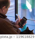 A man with a cat and smartphone in public transport. High quality photo 119618829