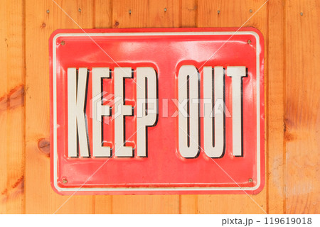 Keep out. Metal sign with an inscription on a wooden background. Metal warning sign. Vintage object. Keep out. Metal sign with an inscription on a wooden background. Metal warning sign. Vintage object. 119619018