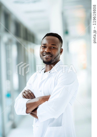 Confident medical professional, black man in bright hallway 119619808