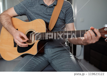 Guitarist on acoustic guitar playing melody. Close up musician instrument 119623122