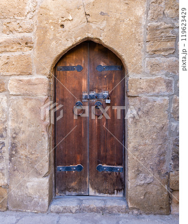 Exploring the Ancient Wooden Door of the Ateshgah Fire Temple in Baku, Azerbaijan During a Sunny Day Exploring the Ancient Wooden Door of the Ateshgah Fire Temple in Baku, Azerbaijan During a Sunny Day 119623429