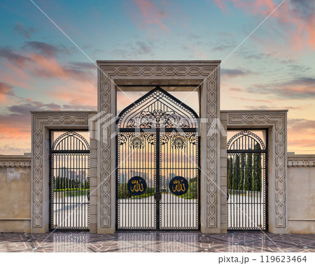 Taza Pir Mosque Side Entrance Illuminated by Sunset in Baku, Azerbaijan, Showcasing Intricate Architecture and Gates Taza Pir Mosque Side Entrance Illuminated by Sunset in Baku, Azerbaijan, Showcasing Intricate Architecture and Gates 119623464