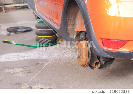 Car repair. Wheel balancing or repair and change auto tire. Technicians are fixing wheel in garage. Car repair. Wheel balancing or repair and change auto tire. Technicians are fixing wheel in garage. 119623888