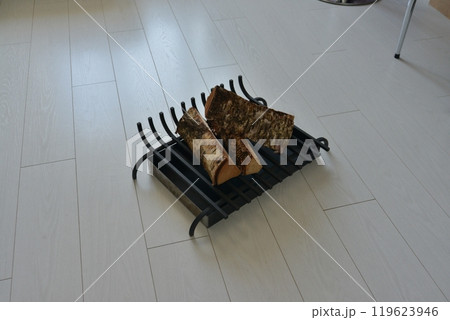 An object photo shoot of black grilles for fireplaces on a light background in the interior. 119623946