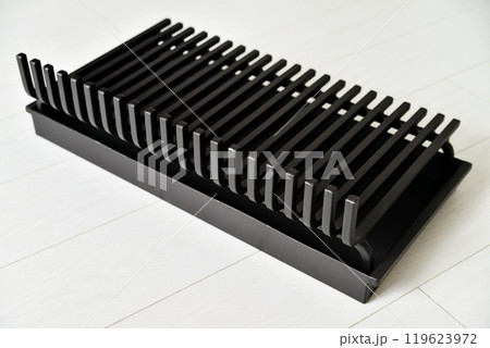 An object photo shoot of black grilles for fireplaces on a light background in the interior. An object photo shoot of black grilles for fireplaces on a light background in the interior. 119623972