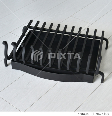 An object photo shoot of black grilles for fireplaces on a light background in the interior. 119624105