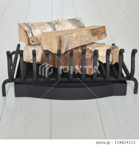 An object photo shoot of black grilles for fireplaces on a light background in the interior. 119624115