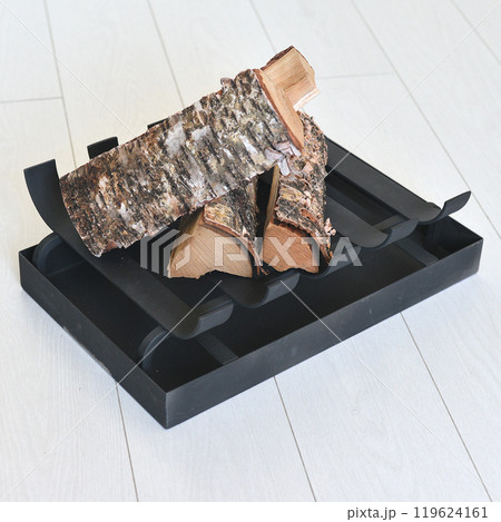 An object photo shoot of black grilles for fireplaces on a light background in the interior. 119624161