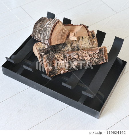 An object photo shoot of black grilles for fireplaces on a light background in the interior. An object photo shoot of black grilles for fireplaces on a light background in the interior. 119624162