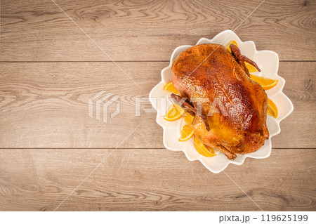 Roast duck with orange. Christmas Dinner. Christmas food concept. top view. copy space Roast duck with orange. Christmas Dinner. Christmas food concept. top view. copy space 119625199