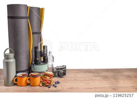 healthy snack of tourists with different camping equipment on a wooden board. food for the trip isolated on white healthy snack of tourists with different camping equipment on a wooden board. food for the trip isolated on white 119625257