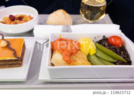 おいしいビジネスクラスの機内食オヒョウの魚料理と野菜とシャンパン、チョコレートケーキ おいしいビジネスクラスの機内食オヒョウの魚料理と野菜とシャンパン、チョコレートケーキ 119625712