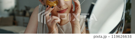 Applying Under-Eye Patches for Skincare Treatment 119626638