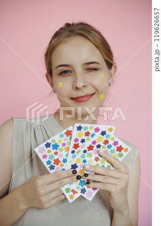 Portrait of Woman Holding Colorful Star Stickers Portrait of Woman Holding Colorful Star Stickers 119626657