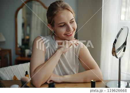 Smiling Woman Admiring Reflection in Bedroom Mirror Smiling Woman Admiring Reflection in Bedroom Mirror 119626668