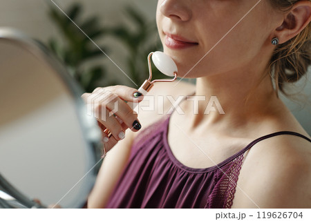 Using Jade Roller for Facial Massage at Home Using Jade Roller for Facial Massage at Home 119626704