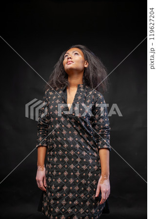 Pensive woman in traditional black kurta against 119627204
