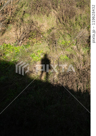 The shadow of a man in the distance looking down. The shadow of a man at the top The shadow of a man in the distance looking down. The shadow of a man at the top 119628432