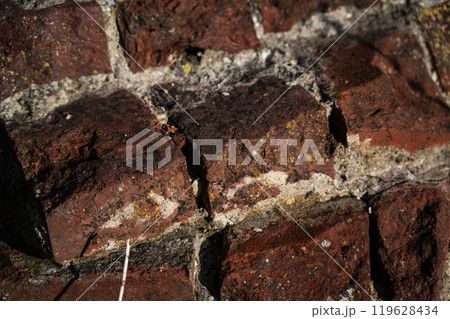 The ruins of the red brick fortress wall. Brick wall background 119628434