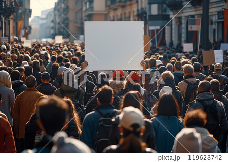 People are gathered for a strike, displaying blank placards in a demonstration down a bustling city street under clear skies 119628742