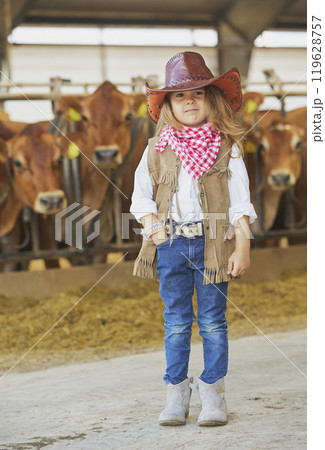 Charming child in a cowboy costume on a cows farm in Denmark 119628757