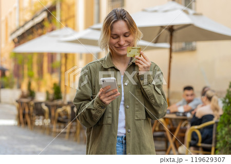 Woman using credit bank card and smartphone while transferring money, purchases online shopping 119629307