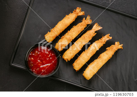 Golden fried shrimp sticks with crispy breading and dipping sauce. Perfect for appetizers or snacks 119630703