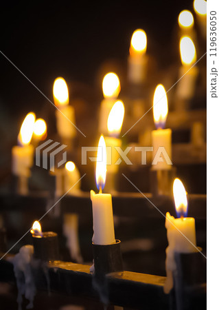 Stunning array of glowing candles forming rows and casting warm light, ideal for creating a peaceful and spiritual ambiance. Perfect for meditation, reflection, or romantic settings 119636050
