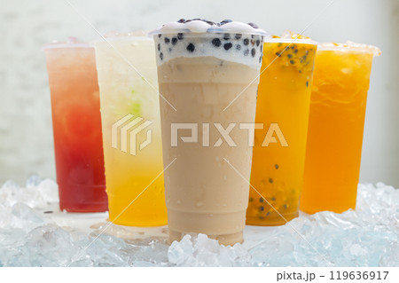 Taiwanese Boba milk tea and Passion fruit smoothies in plastic glass with ice on white background 119636917