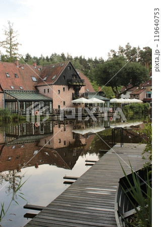 of a residential building with a cafe-restaurant by the river in the forest 119640753