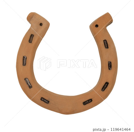 Rustic horseshoe in a traditional U-shape, isolated on white background. The horse shoe is crafted from ceramic with weathered texture. It symbolizes luck and protection. Top view, flat lay. Rustic horseshoe in a traditional U-shape, isolated on white background. The horse shoe is crafted from ceramic with weathered texture. It symbolizes luck and protection. Top view, flat lay. 119641464
