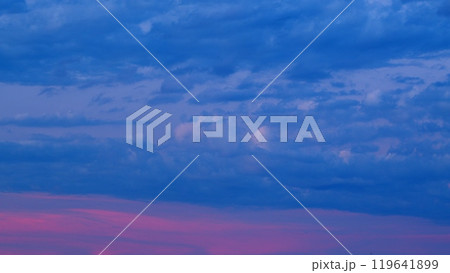 Beautiful Flying blue and Pink Clouds. Romantic colorful sunset. Evening Colorful Delightful Clouds. Timelapse. 119641899
