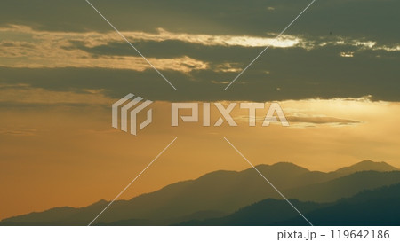 Beautiful Golden Sunrise. Silhouette Of The Mountain Hills Against Sunrise Sky. Real time. Beautiful Golden Sunrise. Silhouette Of The Mountain Hills Against Sunrise Sky. Real time. 119642186