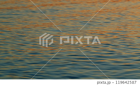 Golden Sea At Sunset. Reflection And Ripples On Sea Water Surface At Sunset. Slow motion. 119642587