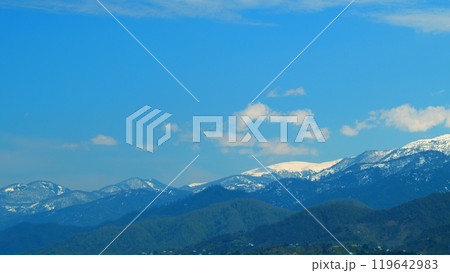 Mountain Peaks And Cloudy Sky. Landscape With Pine Trees Covered With Snow In Spruce Forest In Cold Mountains. Real time. Mountain Peaks And Cloudy Sky. Landscape With Pine Trees Covered With Snow In Spruce Forest In Cold Mountains. Real time. 119642983