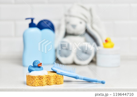 Yellow rubber duck, soap, bath foam on bath background, children bath accessories Yellow rubber duck, soap, bath foam on bath background, children bath accessories 119644710