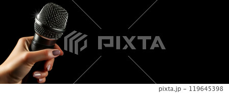 Closeup of a Female Hand Holding a Modern Microphone on Black Background - Generative Ai 119645398