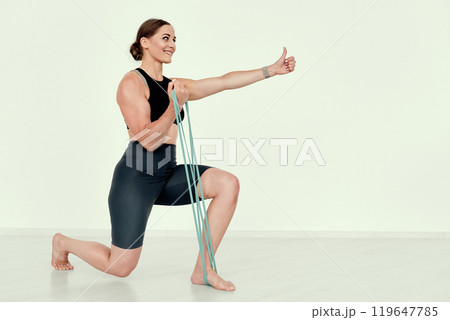 Fitness Coach Performing Lunge Exercise with Resistance Band Fitness Coach Performing Lunge Exercise with Resistance Band 119647785