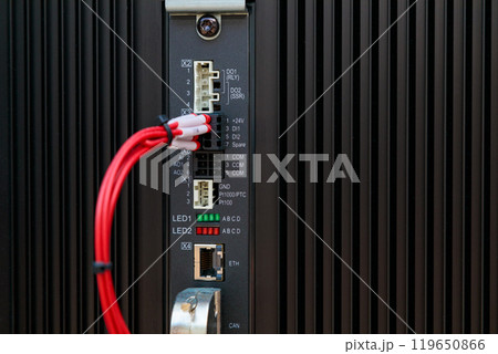 Programmable logic controller with red cable connecting to input output module 119650866