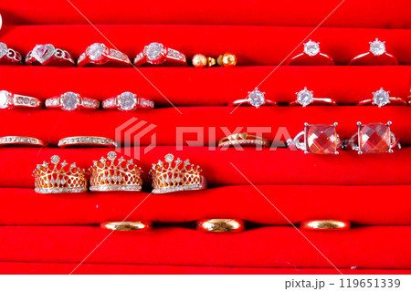 wedding rings or jewellery with golden ring in red box on white background. 119651339