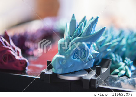 Beautiful creative multi-colored object printed on a 3D printer from melted colored plastic. Artistic model printed by 3D printer from multi-colored plastic. Modern additive 3d printing technologies 119652075