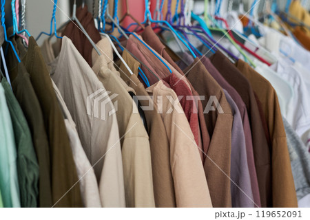 Row of hangers with casual apparel 119652091