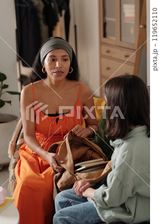 Engaging Conversation Between Two Women Indoors 119652110