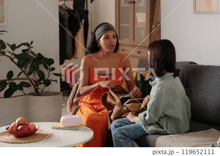Mother Having Serious Conversation with Daughter in Living Room 119652111