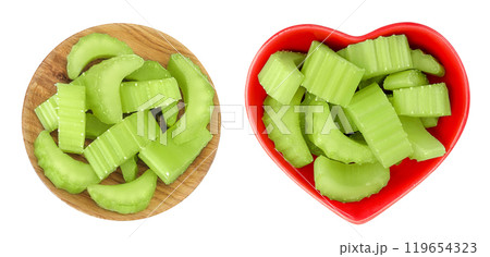 fresh celery in wooden and ceramic bowl isolated on white background. Top view. Flat lay fresh celery in wooden and ceramic bowl isolated on white background. Top view. Flat lay 119654323