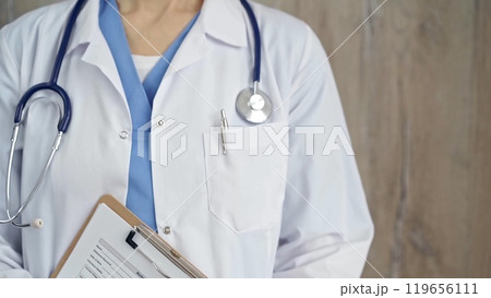 Confident healthcare professional with stethoscope. Close-up of a medical doctor in white coat with medication history record form and clipboard. Medicine concept 119656111