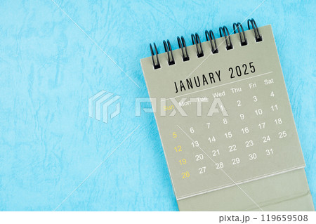 January 2025 desk calendar on blue background. January 2025 desk calendar on blue background. 119659508
